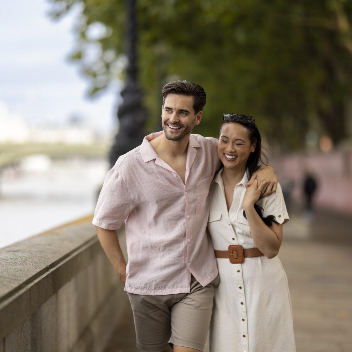 A couple enjoying a walk down the Thames river.